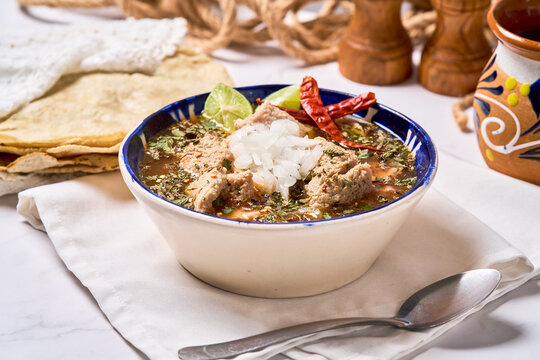 Authentic Mexican tripe soup menudo or mondongo served in a clay bowl.