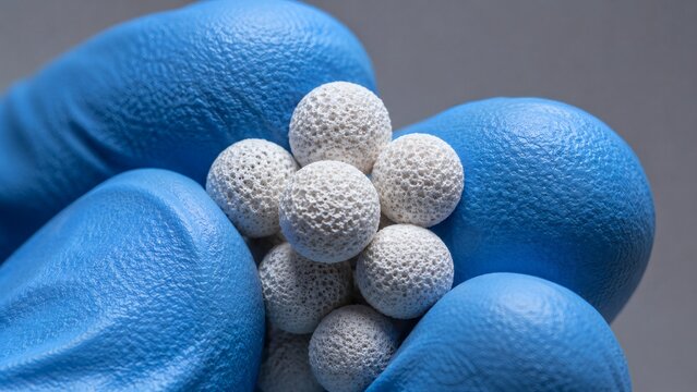 Fingers Holding Absorbent Zeolite Pellets