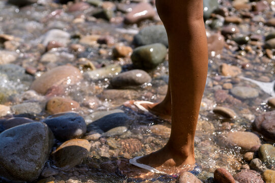 Young person wading in clear river water