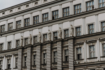 Obraz premium Historic building facade with classical sculptures and windows in Belgrade Serbia. Concept of heritage architecture, culture and European history
