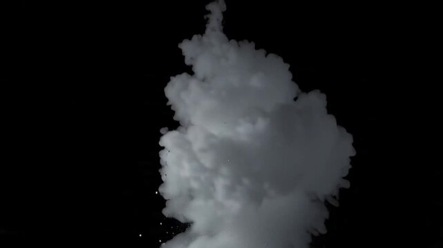 Explosion of white powder and smoke against a dark background.