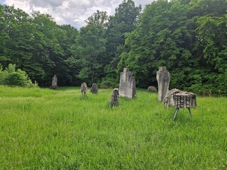 Open-air museum stones in various shapes carved over time exhibited in the middle of nature in a forested mountain glade © Langa
