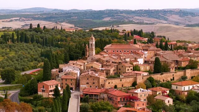Italy San Quirico d'Orcia aerial view 4K drone footage of Tuscany rolling hills valley background red roof tiles historic borgo townscape, classical Val d'Orcia landscape overflight countryside 