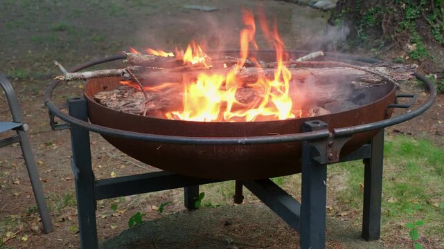 Cozy outdoor fire pit burning in a backyard setting
