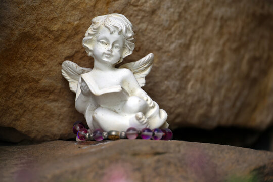 religious symbols, figurines and votive offerings to Mary in a stone grotto