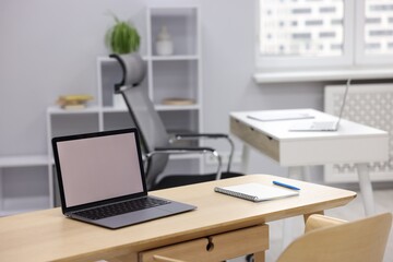 Naklejka premium Desks with laptops, stationery, other furniture and decor. Interior design