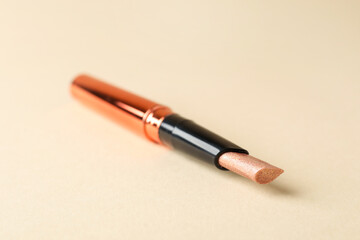 Fototapeta premium Highlighter stick on beige background, closeup. Space for text