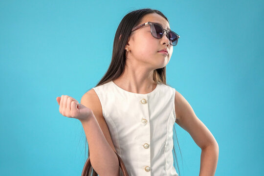 Young girl gesturing with a dismissive or playful hand