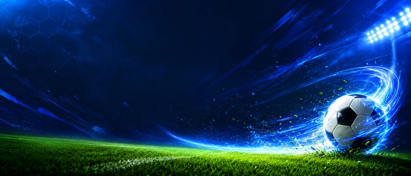 Futuristic Soccer Ball on Grass with Blue Energy Trail and Stadium Lights