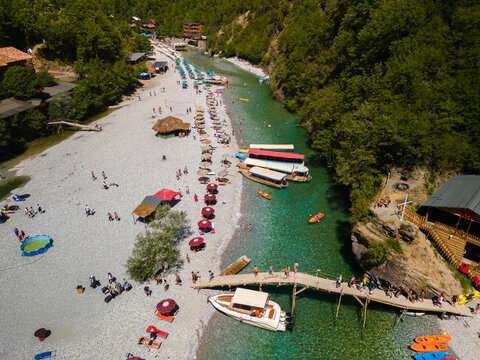 Stunning aerial drone shot of the emerald water and steep mountain cliffs at the final section of Komani Lake and Shala River canyon in Albania.