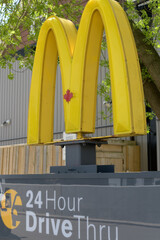 Fototapeta premium iconic Golden Arches outside entrance to McDonald's Canada fast food restaurant location at 31 Woodward Av #29 (seen off Queen E), Toronto