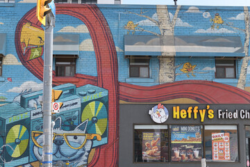 Naklejka premium mural and sign on the side of Heffy's Fried Chicken, a restaurant, located at 1054 Kingston Rd (at Victoria Park Av), Scarborough, Toronto