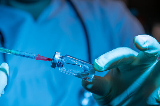heathcare professional preparing an intravenous injection with vial