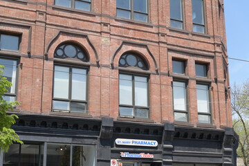 Naklejka premium exterior of historic building (Orient Hall Masonic Lodge or Poulton Block) and sign of St. Mary Pharmacy located 796 Queen St E, Toronto