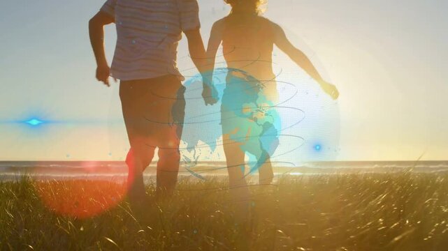 Couple holding hands spotting sun and chasing it down dune, globe wrapping legs, scaling for travel