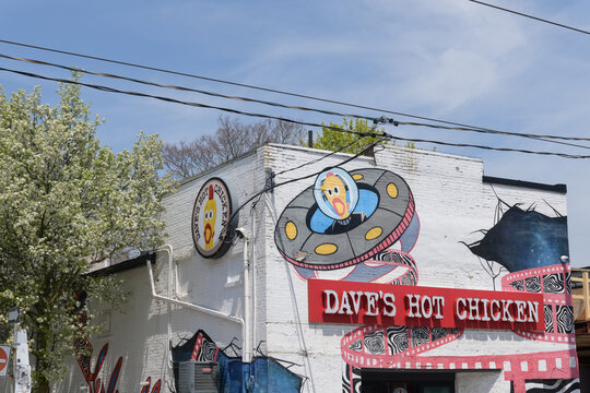 exterior building facade and sign of Dave's Hot Chicken located at 1130 Queen St E, Toronto