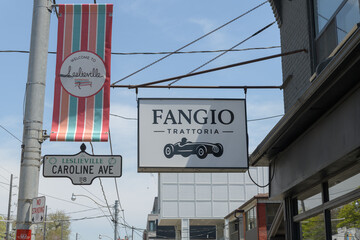Naklejka premium projecting signs outside Fangio Trattoria, a restaurant in Leslieville, 1111 Queen St E, Toronto