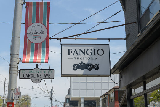 projecting signs outside Fangio Trattoria, a restaurant in Leslieville, 1111 Queen St E, Toronto