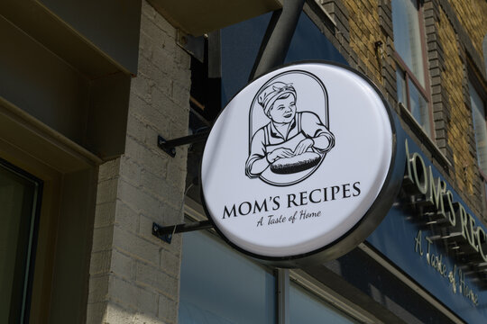 wall-mounted projecting sign outside Mom's Recipes Cafe located at 136 Avenue Rd, Toronto