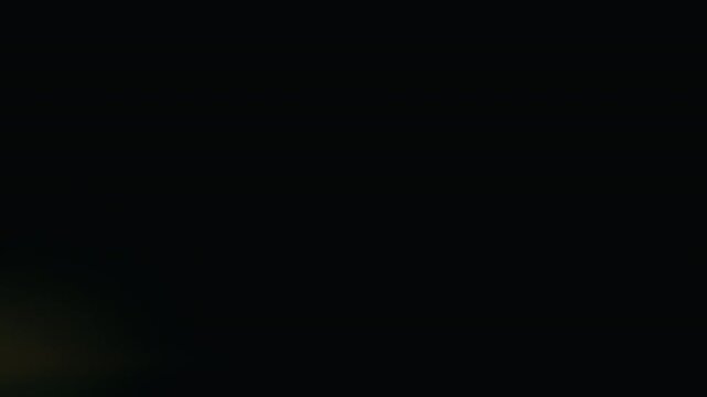 Orange red anamorphic lens flares against dark background