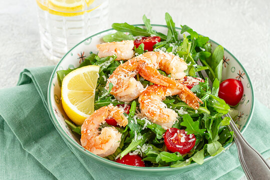Shrimp salad with arugula and cherry tomatoes, with parmesan cheese, healthy food,