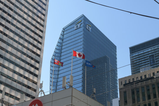 EY sign atop 100 Adelaide St, with view of flags at First Canadian Place, BMO Financial Group, Toronto