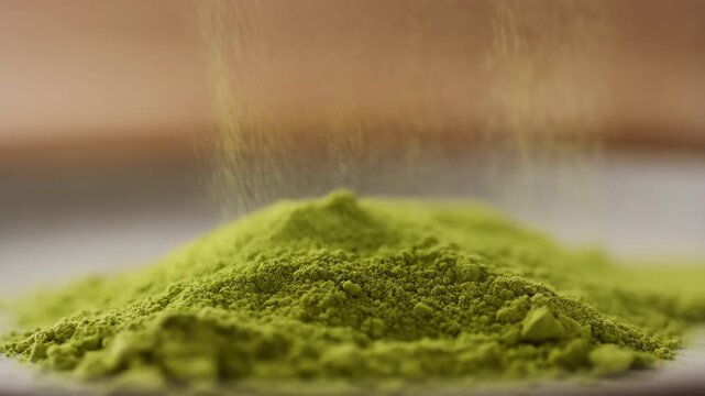 Green matcha powder falling from above in a close-up shot with vibrant texture and fine particles featuring macro photography, food ingredient,