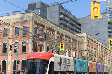 Naklejka premium trolley with advertising wrap for Energy Bird on King St W outside Cibo Wine Bar (historic E.C. Gurney & Co. Stove Foundry building, Toronto