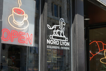 Naklejka premium window signs at Nord Lyon, a bakery, located here at 250 Queen St W, Toronto