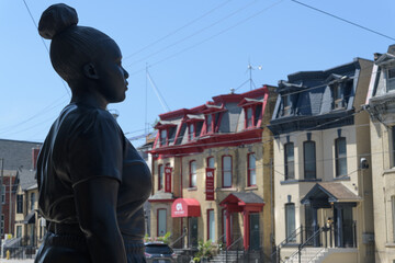Naklejka premium profile of Moments Contained by Thomas J Price installed outside the Art Gallery of Ontario, but facing heritage Victorian houses across the street, Toronto