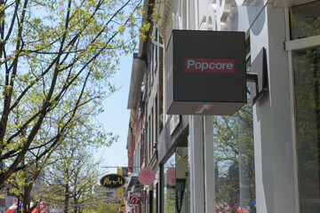 Naklejka premium projecting electronic cube sign wall mounted outside Popcore, a toy store, located at 324 Queen St W, Toronto