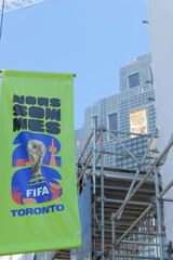 Naklejka premium pole mounted banner advertising for FIFA World Cup 2026 tourney in Toronto (behind) King Toronto Condos