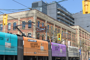 Naklejka premium trolley with advertising wrap for Energy Bird on King St W outside Cibo Wine Bar (historic E.C. Gurney & Co. Stove Foundry building, Toronto