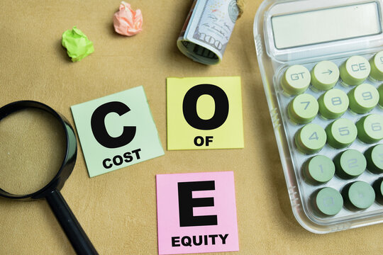Concept of COE - Cost Of Equity write on sticky notes isolated on Wooden Table.