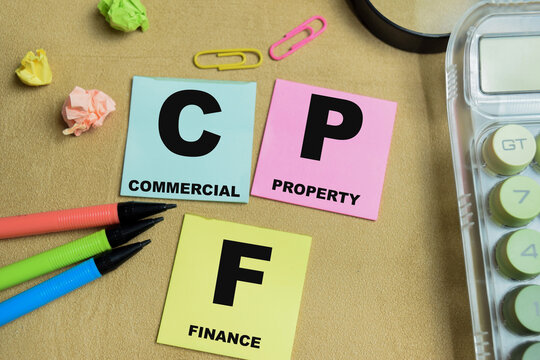 Concept of CPF - Commercial Property Finance write on sticky notes isolated on Wooden Table.