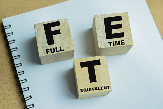 Concept of text FTE - Full Time Equivalent on wooden blocks.