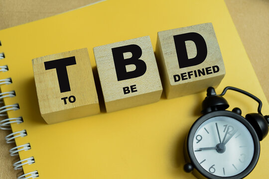 Concept of text TBD - To Be Defined on wooden blocks.