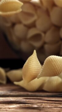 Dry pasta falls on a wooden table. Filmed on a high-speed camera at 1000 fps. High quality FullHD footage