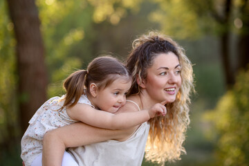Fototapeta premium Mother with her cute little daughter in nature