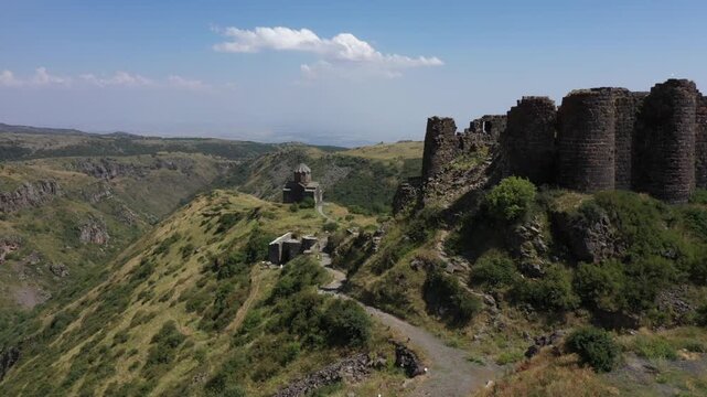 Aerial view of the historic medieval Amberd Fortress in Armenia on a sunny summer day under a blue sky. Spring scene, shot with a drone