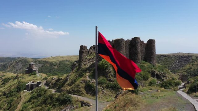 Aerial view of the historic medieval Amberd Fortress in Armenia on a sunny summer day under a blue sky. Spring scene, shot with a drone