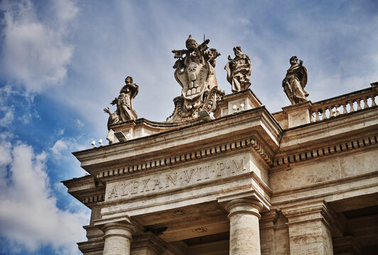 Detail of the St. Peter's Square Colonnade (17th century) in Vatican City, featuring statues of saints and the coat of arms of Pope Alexander VII., Rome, Italy, Europe 