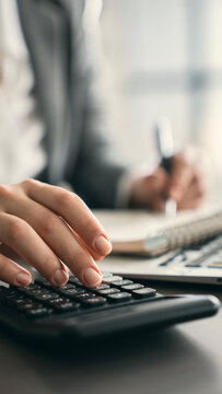Close-up view woman's hand using a calculator