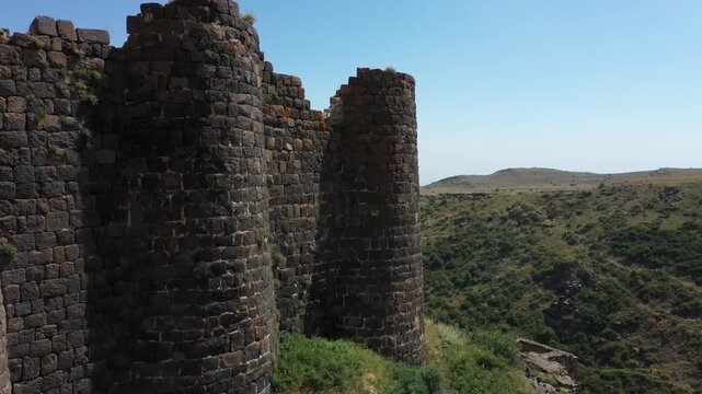 Aerial view of the historic medieval Amberd Fortress in Armenia on a sunny summer day under a blue sky. Spring scene, shot with a drone