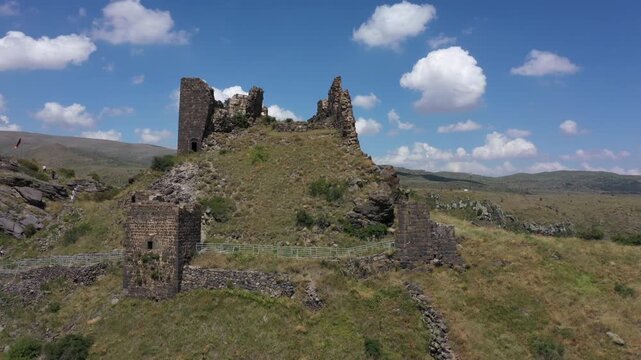 Aerial view of the historic medieval Amberd Fortress in Armenia on a sunny summer day under a blue sky. Spring scene, shot with a drone