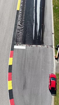 Vertical Aerial Top Down View of Car on Race Track Braking Lane