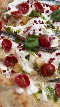 Sumptuous burrata pizza accented by herbs and vegetables
