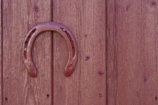 Painted Horseshoe on Weathered Wooden Door with Copy Space