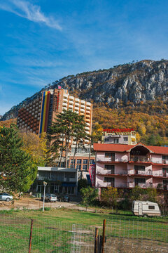 Imposing luxury hotel with spa and treatment base. Mountain and trees with yellow leaves during autumn. Afrodita Hotel , Herculane, Romania, 2019