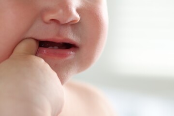 Fototapeta premium Cute child with first baby teeth indoors, closeup. Space for text